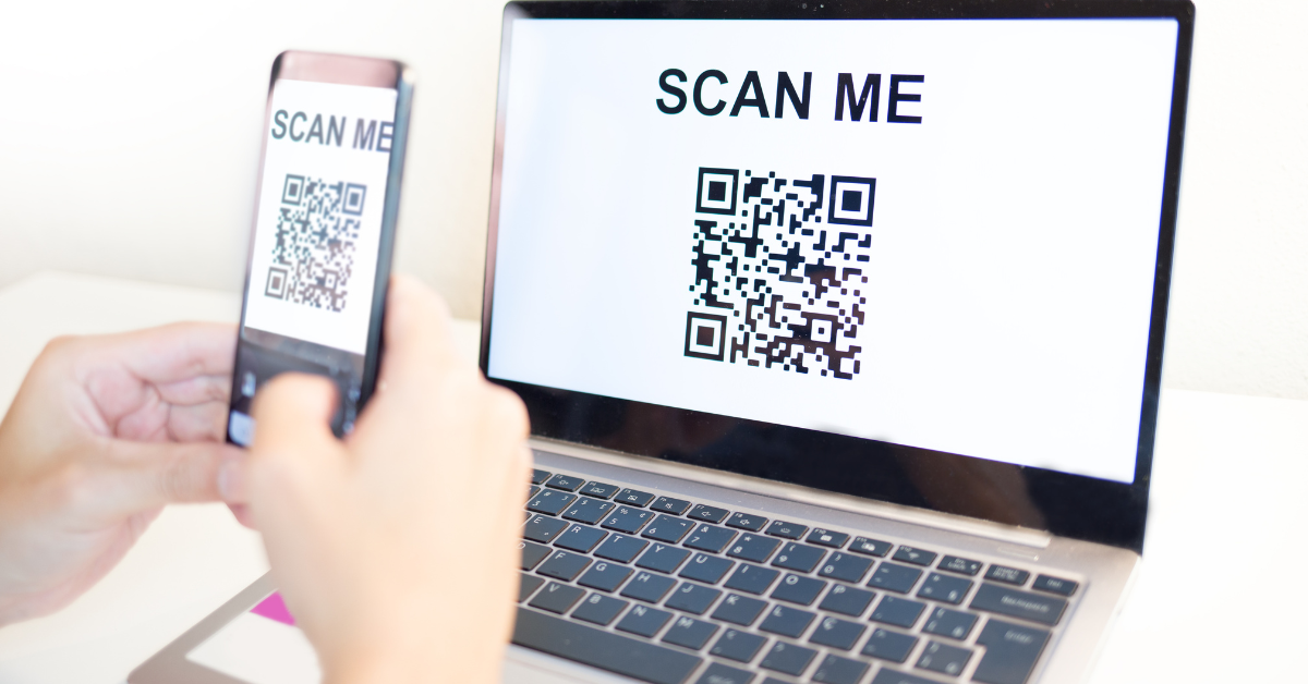 Person holding a phone and scanning a QR code from an email phishing scam